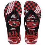 Pair of kids' Havaianas Disney Cars flip-flops with black straps and a red, black, and white racing-inspired print. The footbeds feature Lightning McQueen on one sandal and Mater on the other, accented with checkerboard graphics, bold typography, and Havaianas branding near the heel.