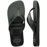 Pair of green, two tone Havaianas flip flops on a white background, with left shoe in focus
