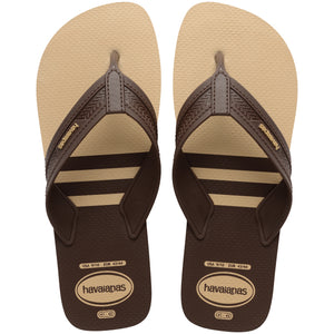 Pair of brown, two tone Havaianas flip flops on a white background