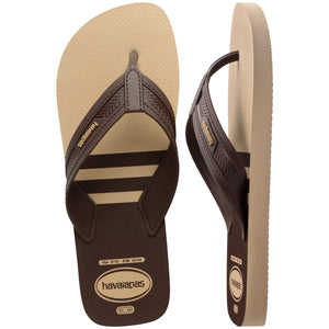Pair of brown, two tone Havaianas flip flops on a white background, with the left shoe in focus