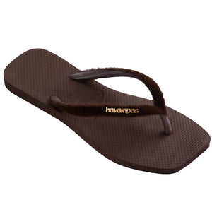 Front right view of brown flip-flops with fuzzy straps and Havaianas brand logo on a white background