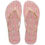 Kids havaianas x LoveShackFancy pink flip flops with floral pattern and bow charm top view