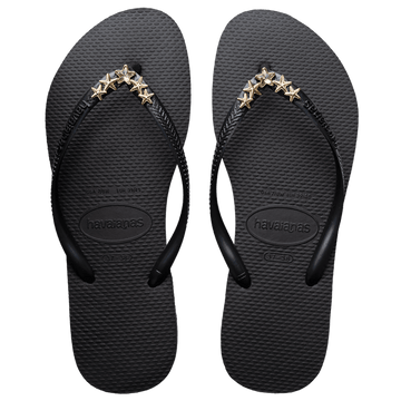 Women's black flip flops with gold star charm embellishment, top view