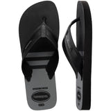 Pair of black, two tone Havaianas flip flops on a white background, with left shoe in focus