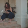 Video of a woman wearing the iconic Havaianas FARM Rio Botanical Beauty while reading a book.